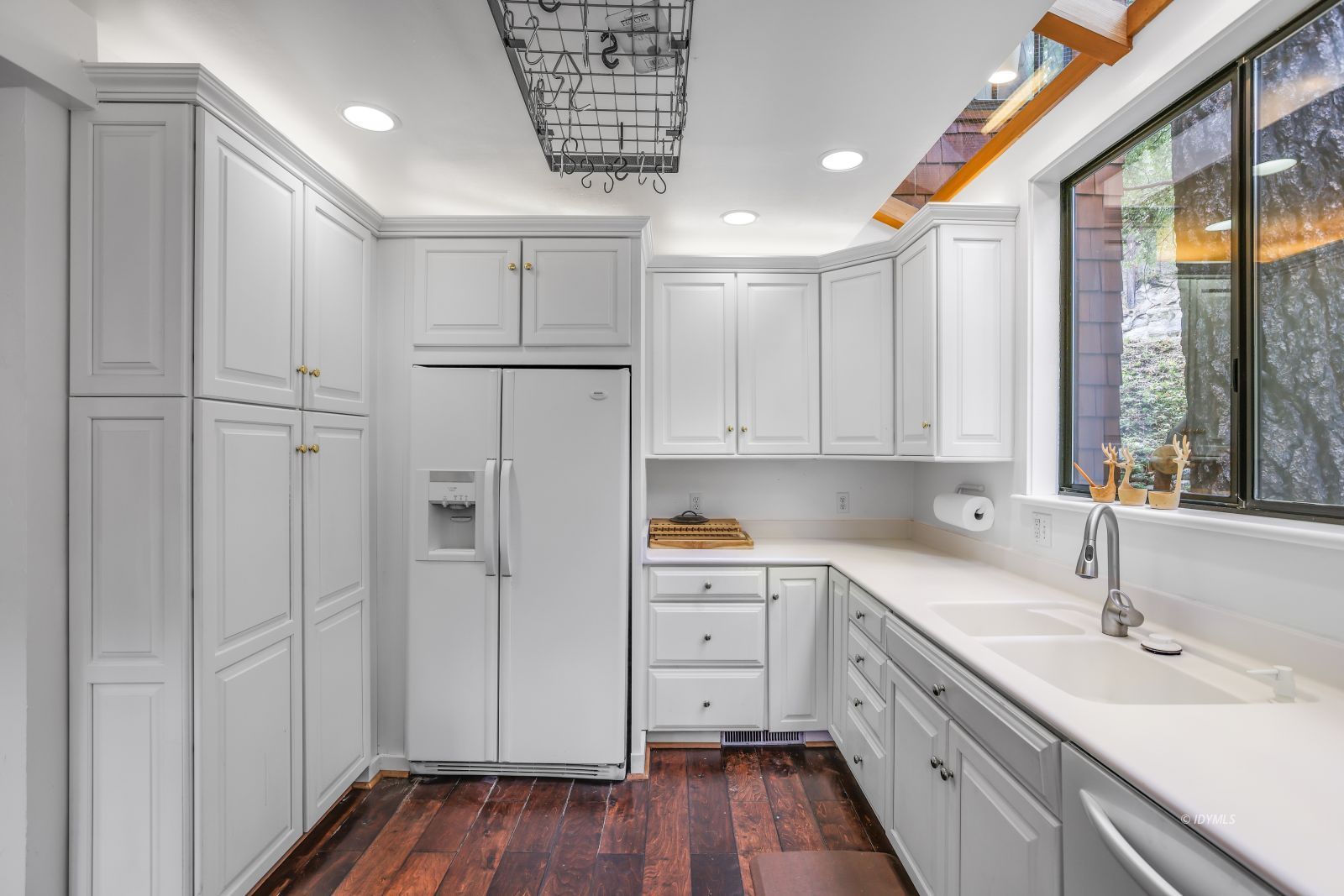 55100 Pine Crest Avenue Idyllwild, CA 92549 - Photo 15 of 50 a kitchen with white cabinets and wooden floors