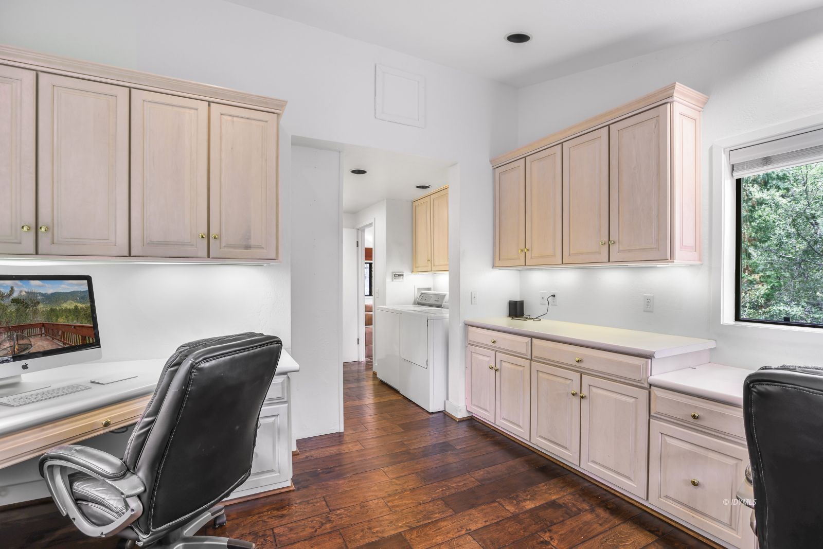 55100 Pine Crest Avenue Idyllwild, CA 92549 - Photo 22 of 50 a kitchen with stainless steel appliances granite countertop a sink dishwasher and white cabinets with wooden floor