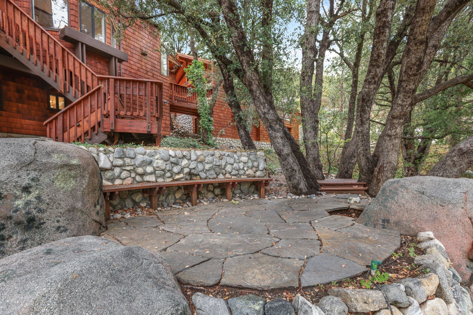 55100 Pine Crest Avenue Idyllwild, CA 92549 - Photo 38 of 50 a view of a chairs and bench in the backyard