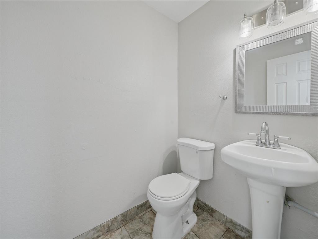 1819 East Grauwyler Road, Unit 178 Irving, TX 75061 - Photo 15 of 22 a bathroom with a sink a toilet and mirror