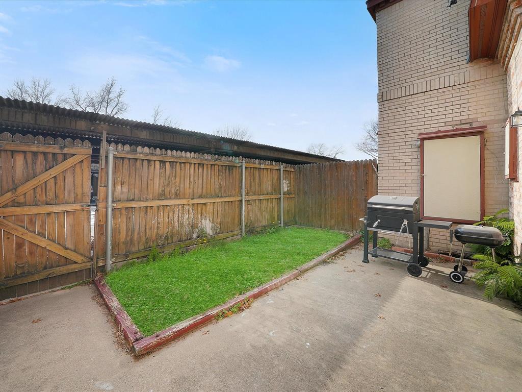 1819 East Grauwyler Road, Unit 178 Irving, TX 75061 - Photo 16 of 22 a view of backyard with seating area and wooden fence