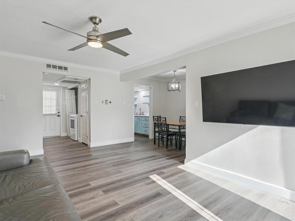 1819 East Grauwyler Road, Unit 178 Irving, TX 75061 - Photo 7 of 22 a view of an empty room with wooden floor and a ceiling fan