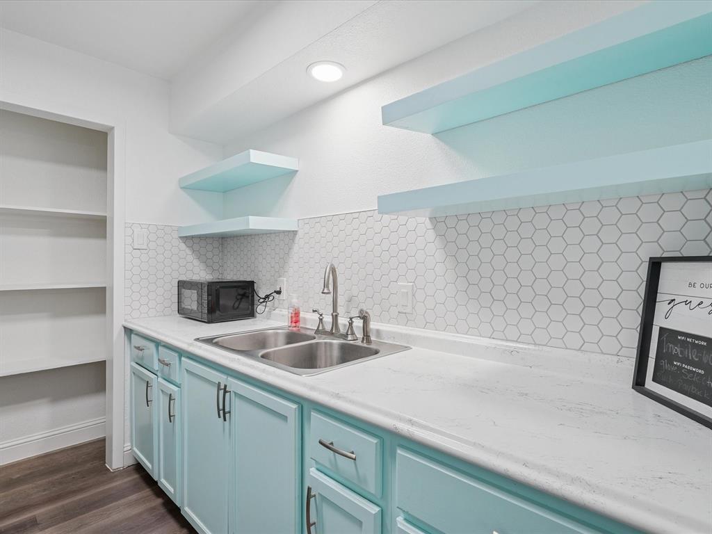 1819 East Grauwyler Road, Unit 178 Irving, TX 75061 - Photo 10 of 22 a kitchen with a sink and a stove with wooden floor