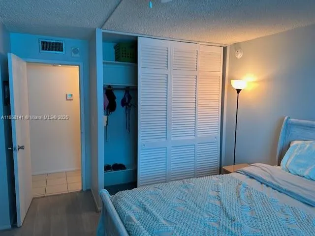 a bedroom with a bed and a shower