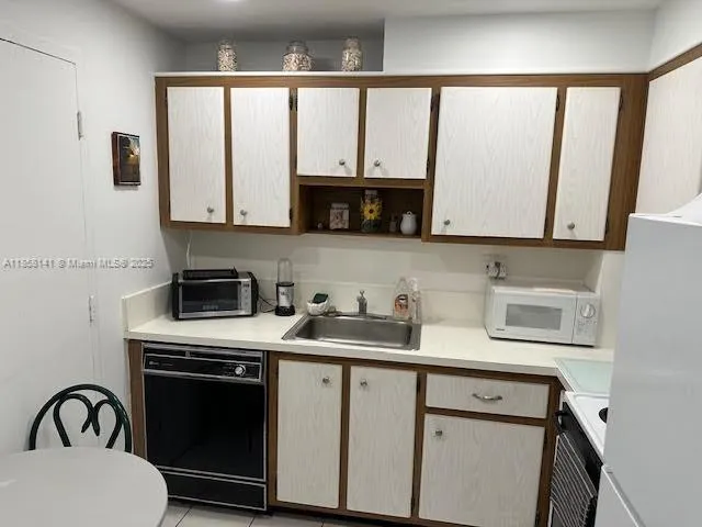 a kitchen with a cabinets a sink and a stove