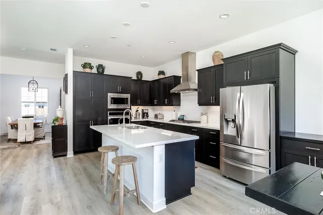 a kitchen with stainless steel appliances a refrigerator stove microwave and sink