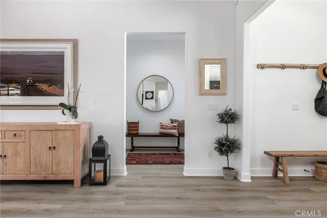 a view of a hallway with entryway wooden floor and front door