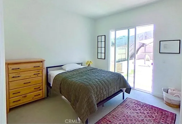 a bed sitting in a bedroom next to a window