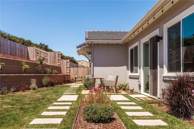 a view of a patio with table and chairs and potted plants
