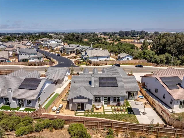 an aerial view of residential houses with outdoor space