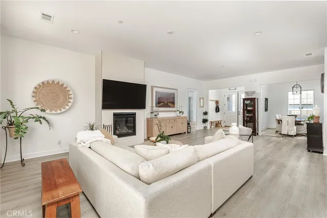 a living room with fireplace furniture and a flat screen tv