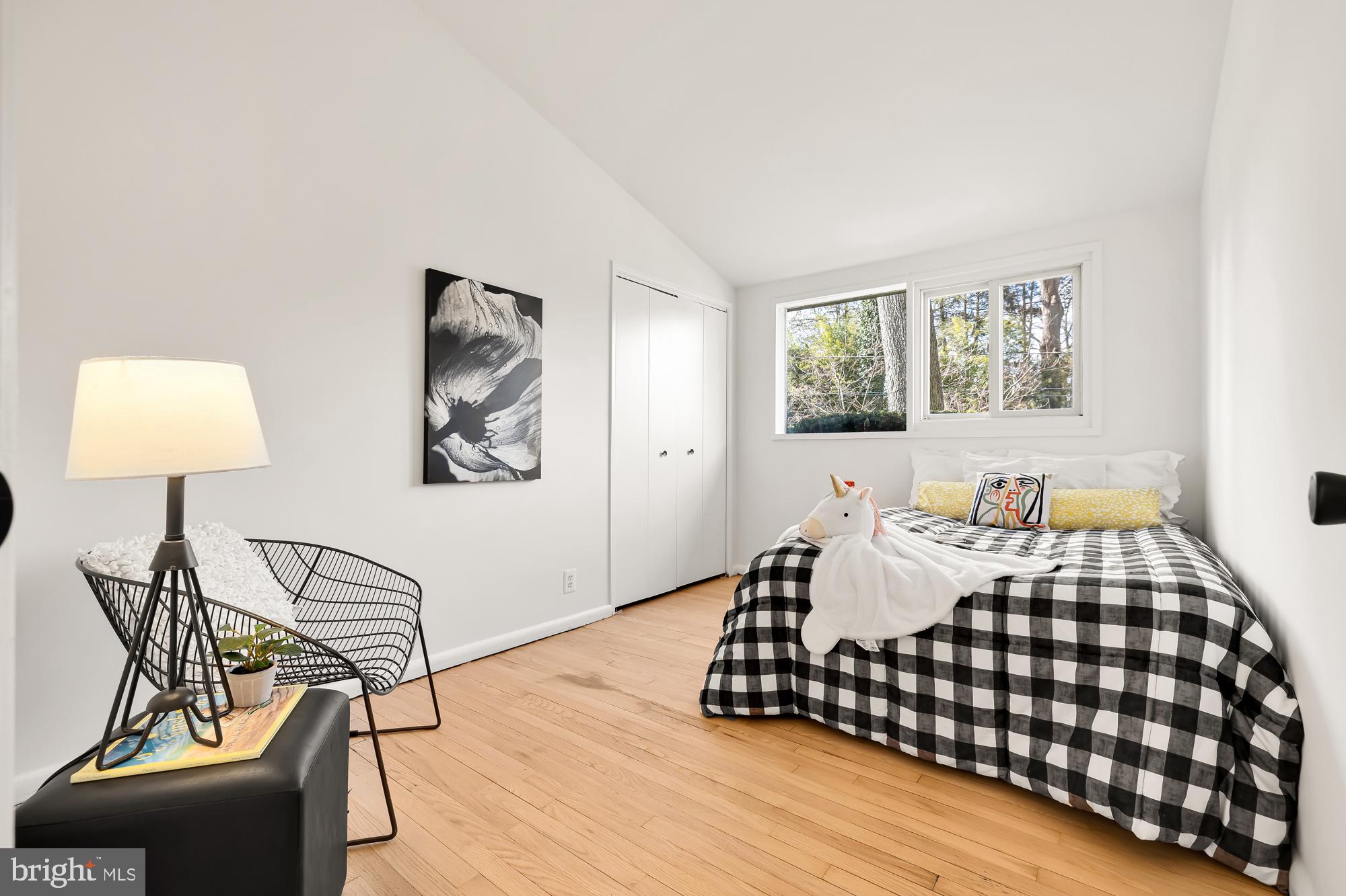 11500 Regnid Drive Silver Spring, MD 20902 - Photo 29 of 50 a bedroom with a bed and lamp on dresser with wooden floor