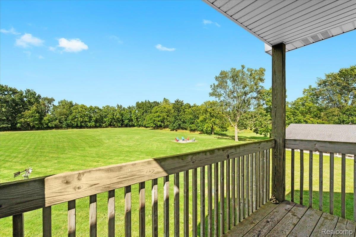 3778 Warner Road Howell, MI 48855 - Photo 16 of 38 Deck with a yard and view of wooded area