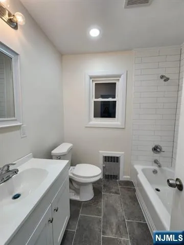 a bathroom with a bathtub sink mirror and toilet