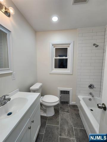 65 Halstead Street, Unit 1 Kearny, NJ 07032 - Photo 13 of 15 a bathroom with a bathtub sink mirror and toilet