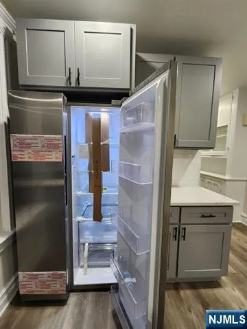 a kitchen with a refrigerator and a sink