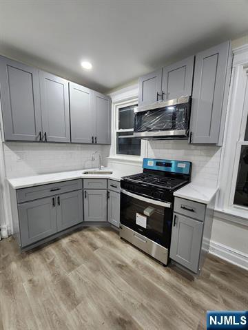 65 Halstead Street, Unit 1 Kearny, NJ 07032 - Photo 3 of 15 a kitchen with stainless steel appliances granite countertop a stove and a sink