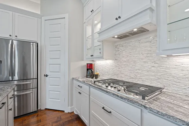 a kitchen with stainless steel appliances granite countertop a stove and a refrigerator
