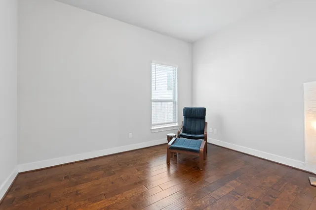 a view of a room with wooden floor and a window
