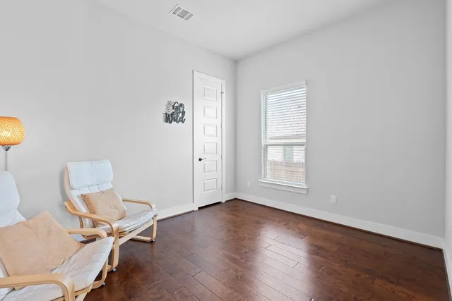 a view of workspace room with wooden floor and fan