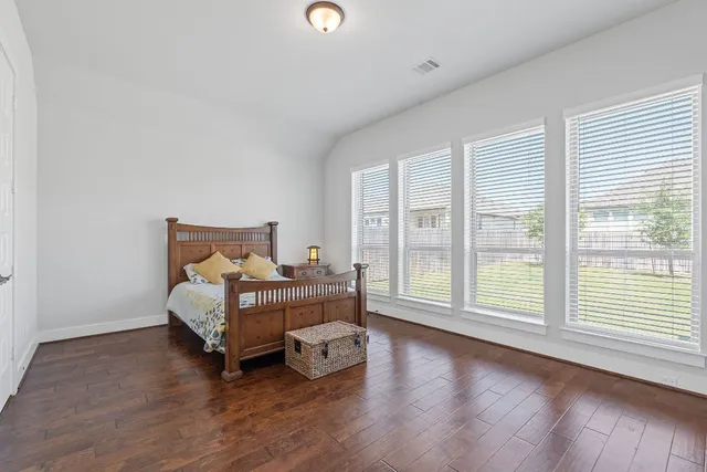 a bed room with a bed and wooden floor
