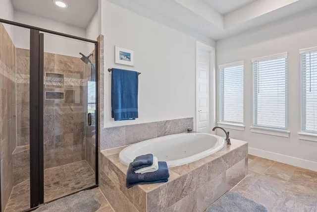 a bathroom with bathtub and a shower