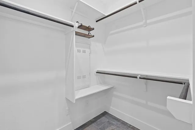 a view of a patio with a table and chairs under an umbrella