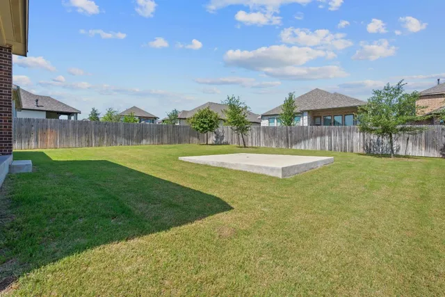 a view of house with a yard
