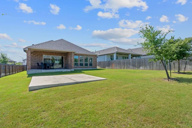 a view of a house with swimming pool yard and furniture