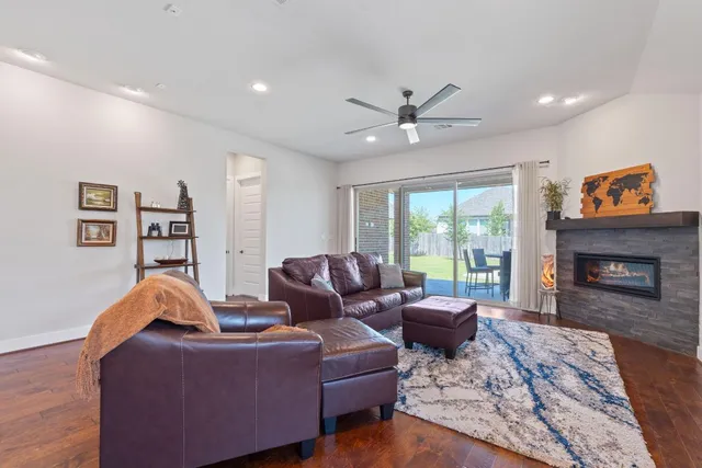 a living room with furniture a large window and a fireplace