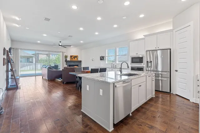 a kitchen with refrigerator and cabinets