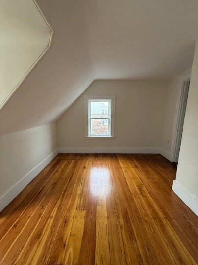 5 Alcott Street, Unit 2 Boston, MA 02134 - Photo 9 of 14 an empty room with wooden floor and windows