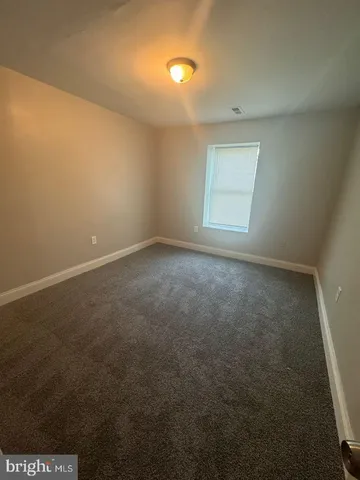 an empty room with a empty space and windows