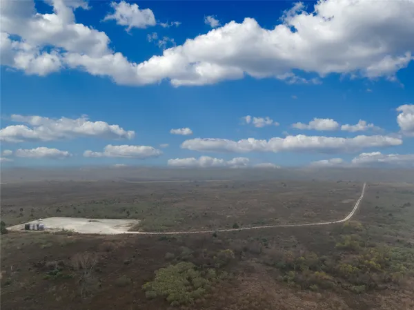 a view of roof with wooden floor and city view
