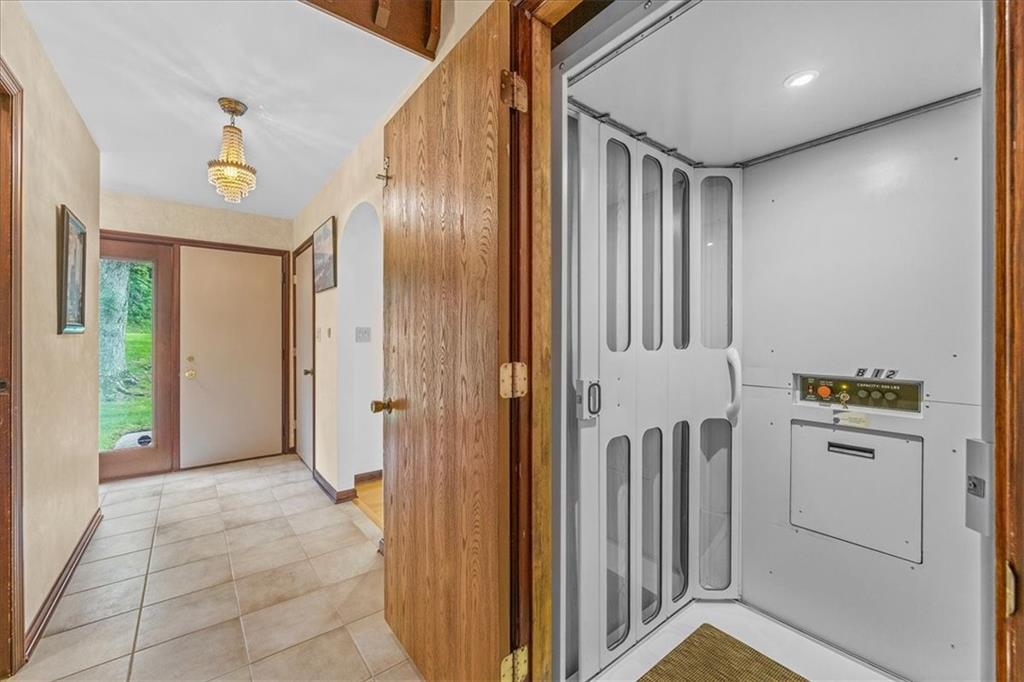 216 Springhouse Lane Pittsburgh, PA 15238 - Photo 17 of 25 a view of a hallway with wooden shelves