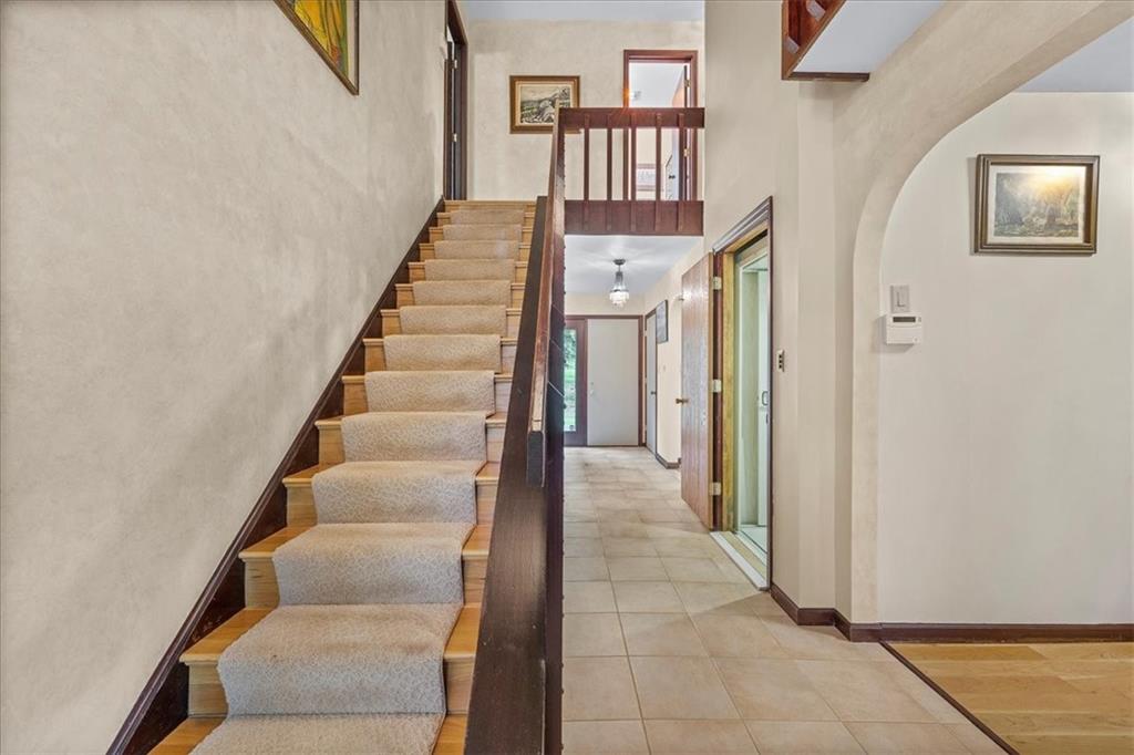 216 Springhouse Lane Pittsburgh, PA 15238 - Photo 6 of 25 a view of staircase with lots of frames on wall and a window