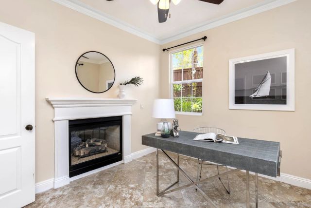 a living room with furniture a window and a fireplace