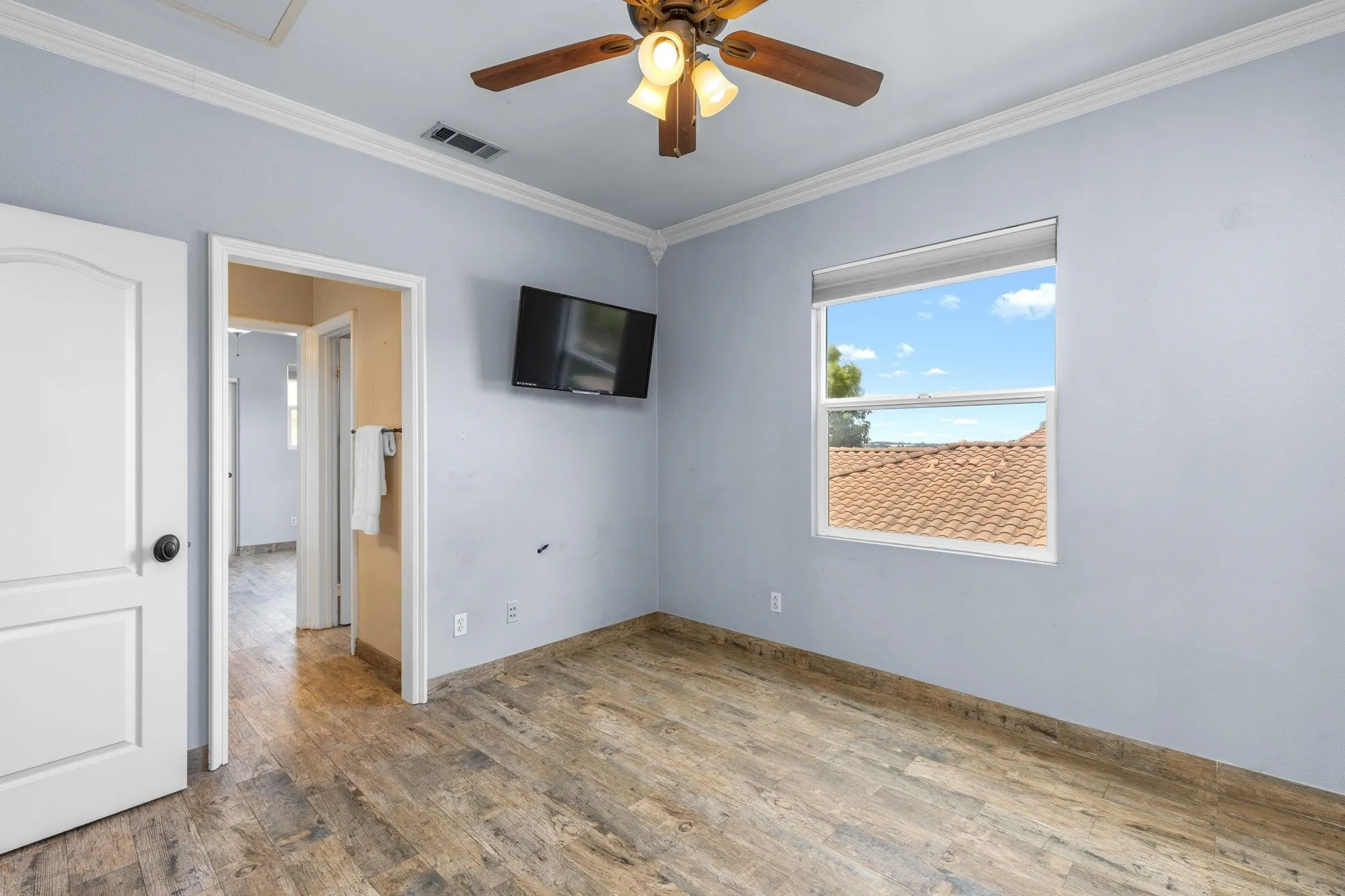 6468 Paseo Cerro Carlsbad, CA 92009 - Photo 28 of 39 an empty room with windows and a chandelier fan
