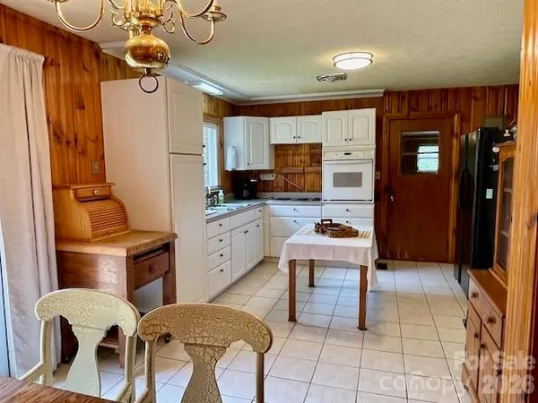 a kitchen with stainless steel appliances kitchen island granite countertop a refrigerator and a stove top oven