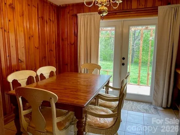 a view of a dining room with furniture and a large window