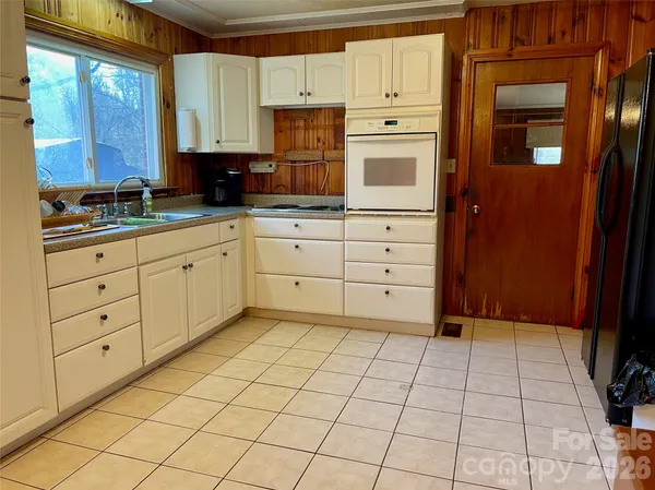 a kitchen with stainless steel appliances a sink and cabinets