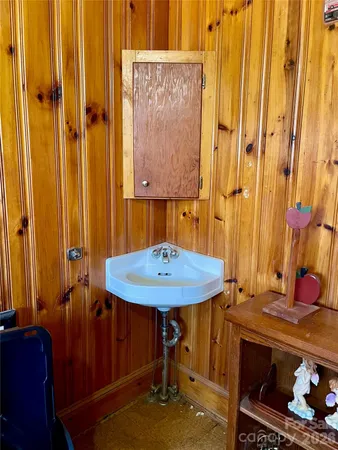 a bathroom with a sink a mirror and a shower curtain