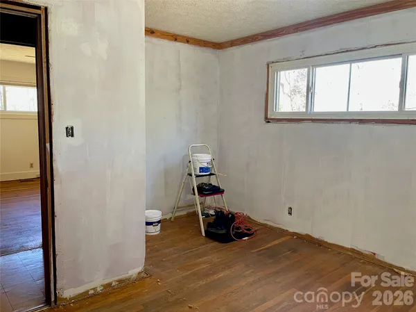 a view of a room with wooden floor and a window
