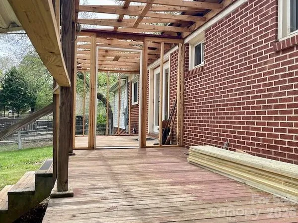 a view of a balcony with wooden floor