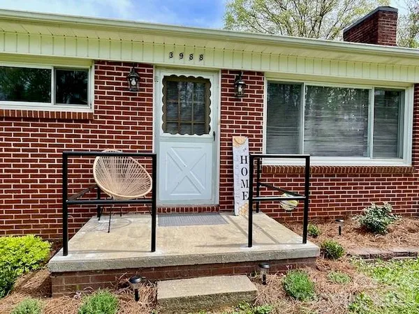 a backyard of a house with table and chairs