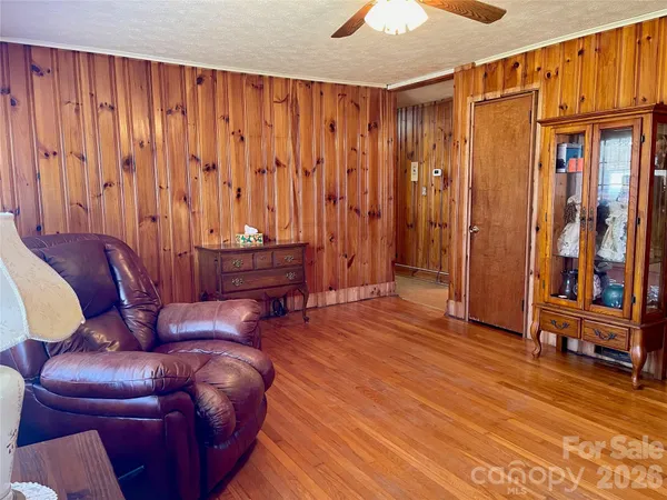 a living room with furniture a desk and chair with wooden floor