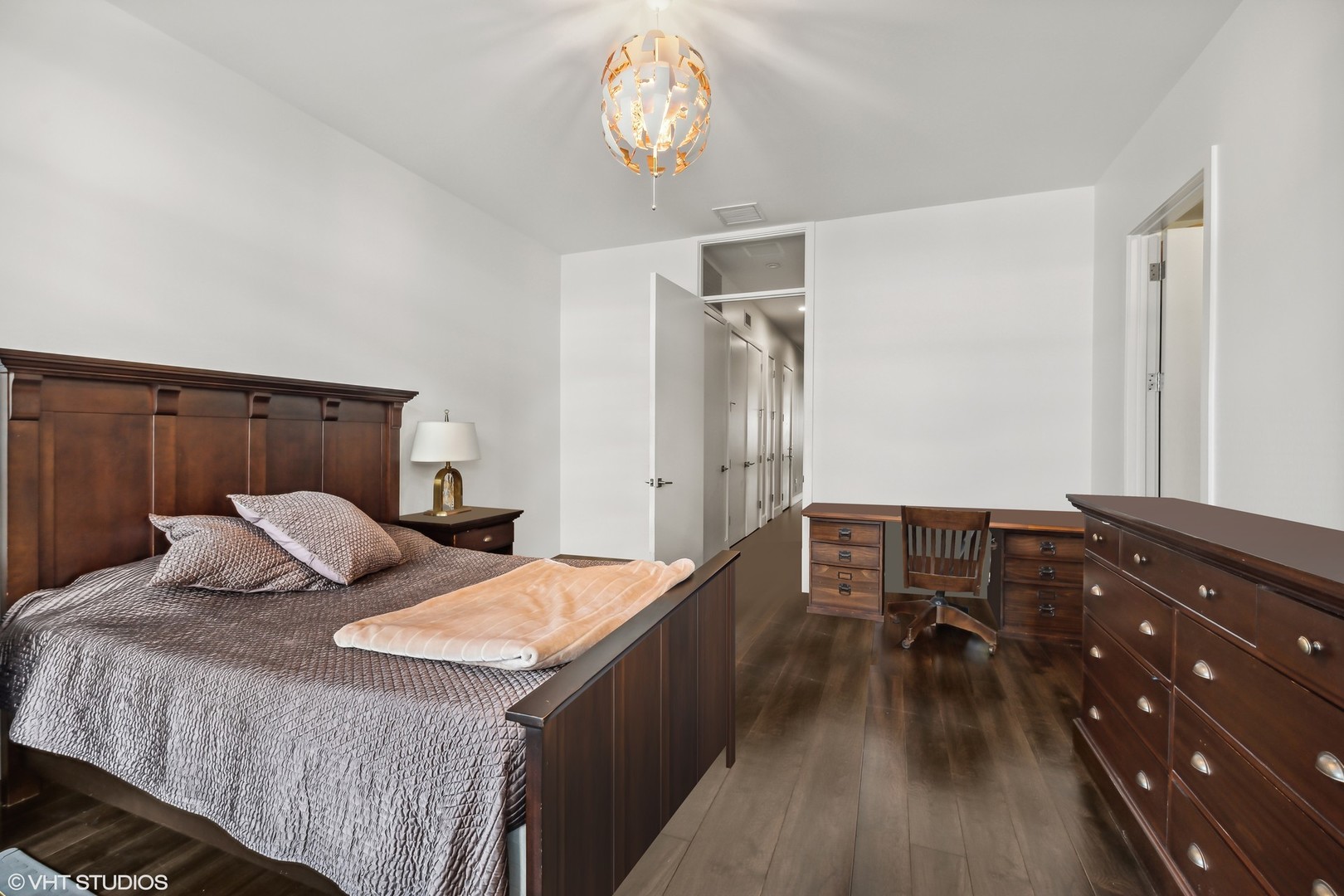 40 North Carpenter Street, Unit 4S Chicago, IL 60607 - Photo 14 of 25 a bedroom with a bed and wooden floor
