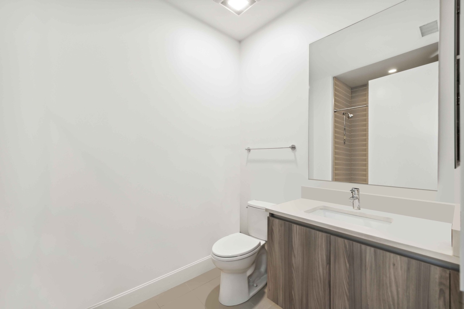 40 North Carpenter Street, Unit 4S Chicago, IL 60607 - Photo 20 of 25 a bathroom with a sink a toilet and a mirror