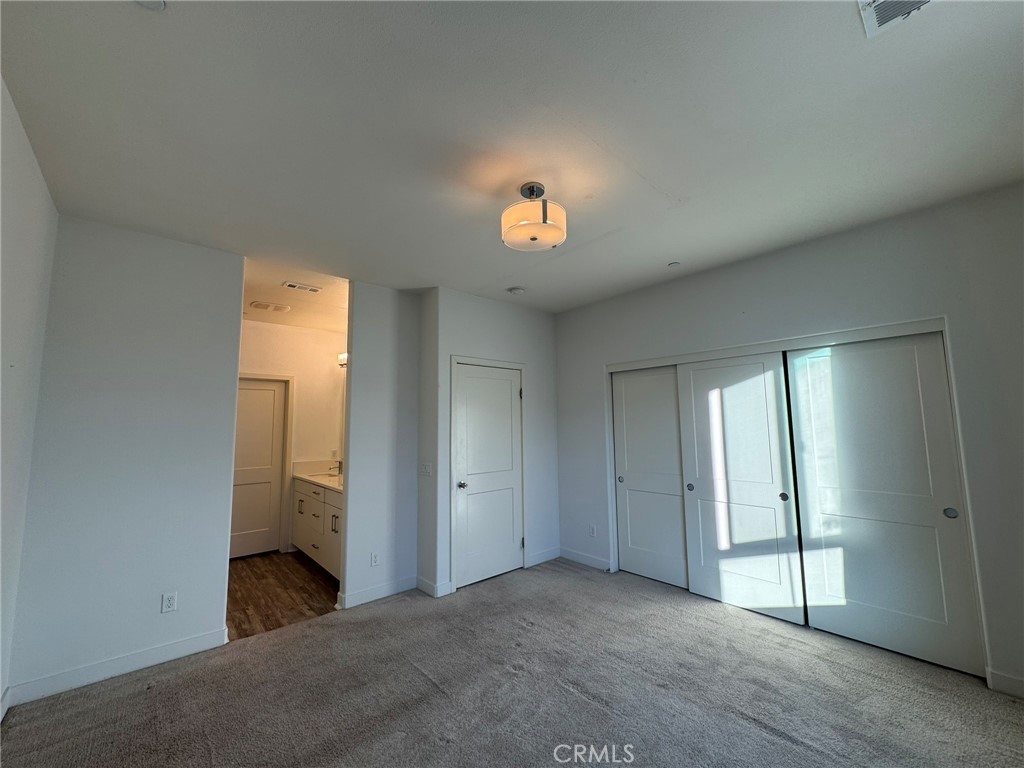 9042 Garvey Avenue, Unit 16 Rosemead, CA 91770 - Photo 11 of 28 an empty room with windows and cabinet