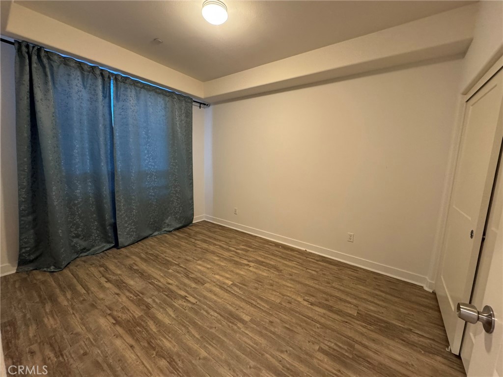 9042 Garvey Avenue, Unit 16 Rosemead, CA 91770 - Photo 18 of 28 a view of empty room with wooden floor